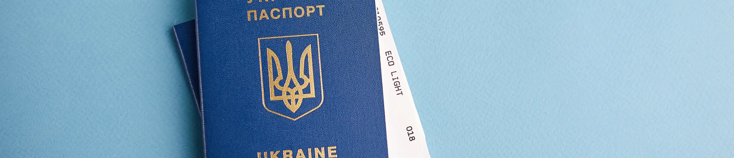 Two Ukrainian passports with a golden trident symbol on a blue background. Biomedical Ukraine passport id. Copy space